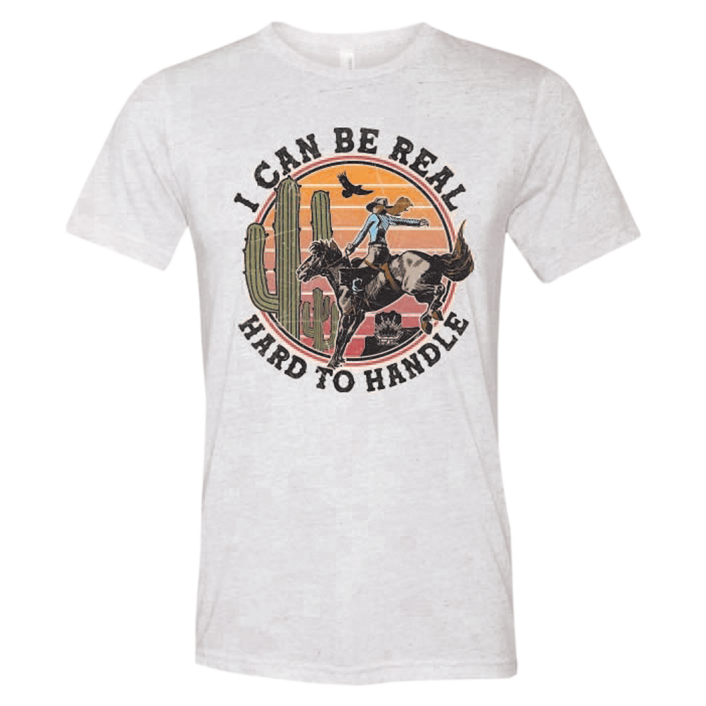 ladies tee-white-"I can be real hard to handle" cowgirl on horse in desert with bird and cactus